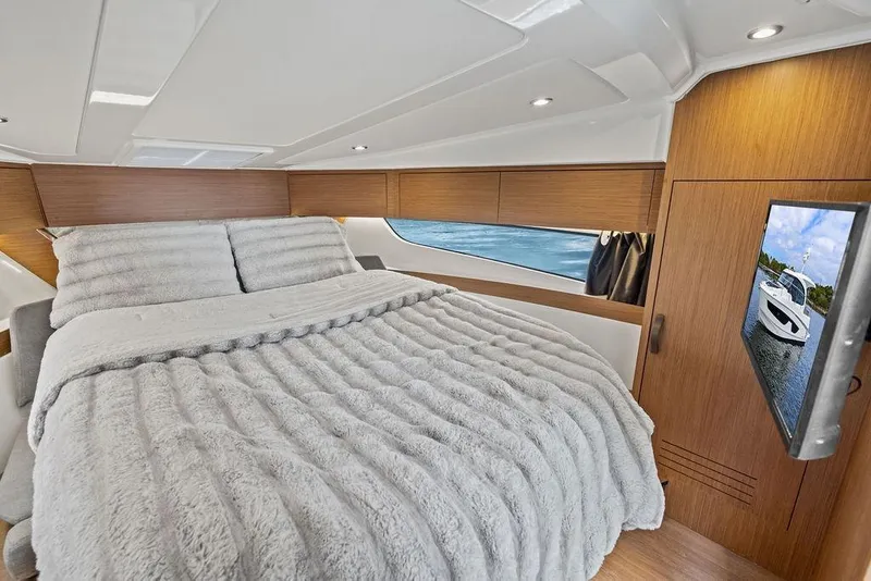 Slide: The Image of Luxurious cabin interior of 2022 Beneteau Antares 11 with cozy bedding and modern design. - 13