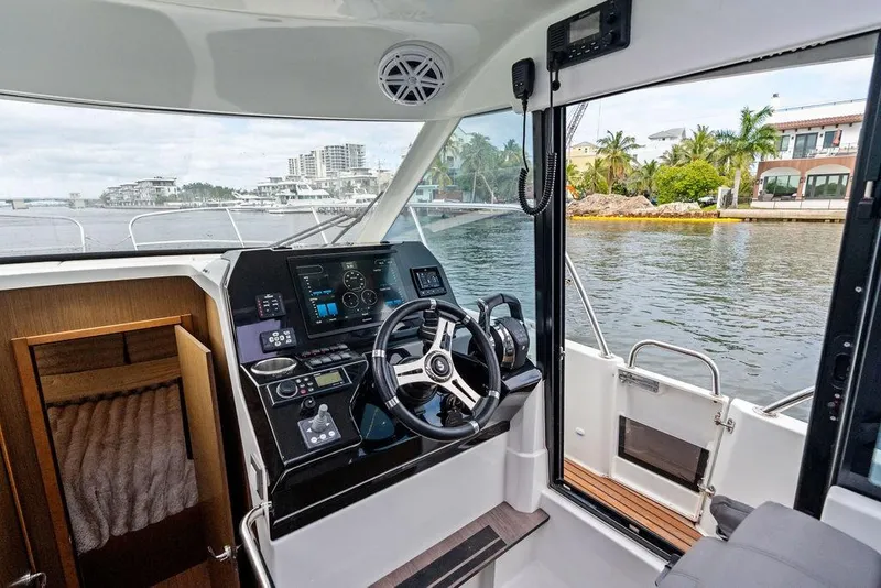 Slide: The Image of Interior view of 2022 Beneteau Antares 11 boat cockpit with modern controls. - 14