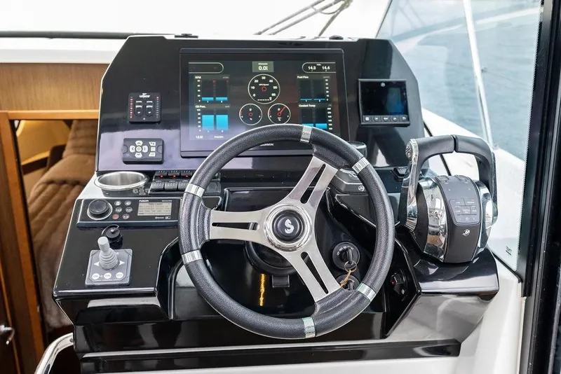 Slide: The Image of Cockpit of 2022 Beneteau Antares 11 with modern controls and navigation display. - 15