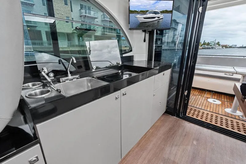 Slide: The Image of Modern kitchen area on a 2022 Beneteau Antares 11 yacht with sleek design and outdoor view. - 17