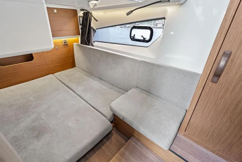 Slide: The Image of Interior of 2022 Beneteau Antares 11, featuring a cozy seating area with modern design. - 18