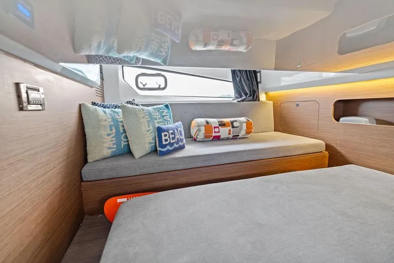 Slide: The Image of Interior of 2022 Beneteau Antares 11 with cozy seating and decorative pillows. - 19