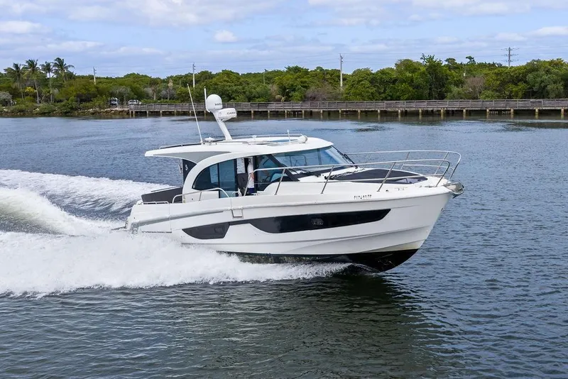 Slide: The Image of 2022 Beneteau Antares 11 cruising on a scenic waterway. - 2