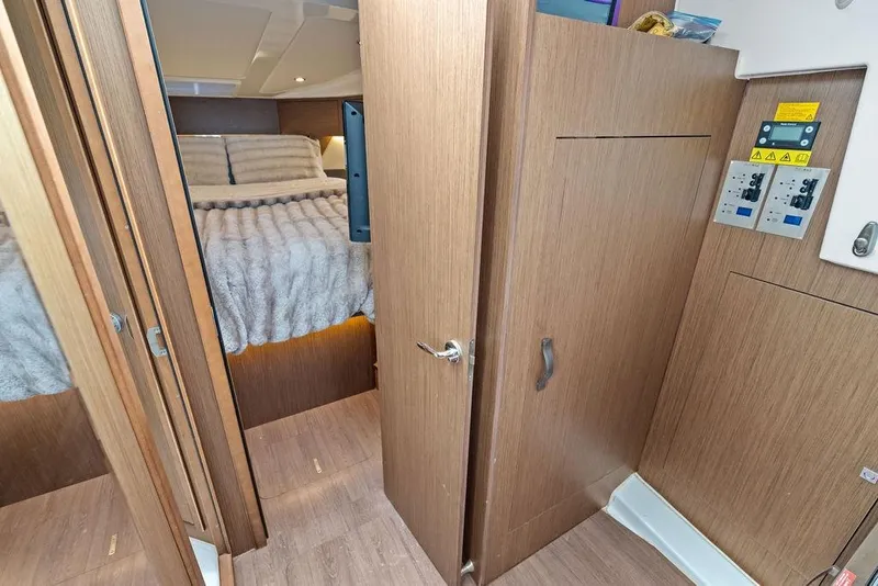 Slide: The Image of Interior cabin of 2022 Beneteau Antares 11 with cozy bed and wooden finishes. - 20