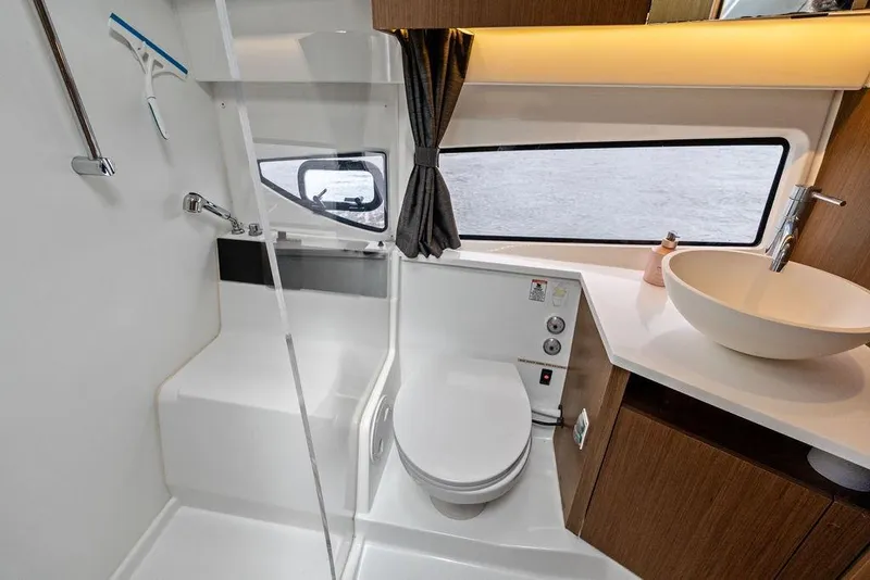 Slide: The Image of Modern bathroom interior of 2022 Beneteau Antares 11 yacht, featuring sleek fixtures and ample lighting. - 22