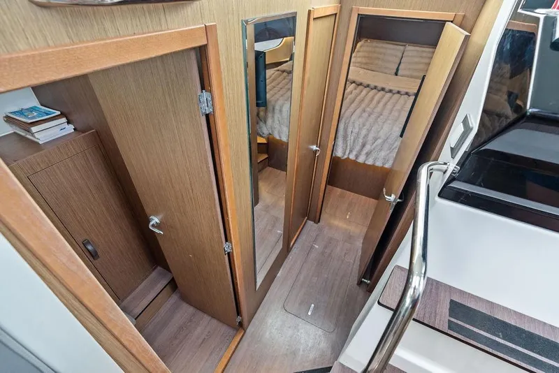 Slide: The Image of Interior view of 2022 Beneteau Antares 11, featuring wooden doors and cozy cabin. - 23