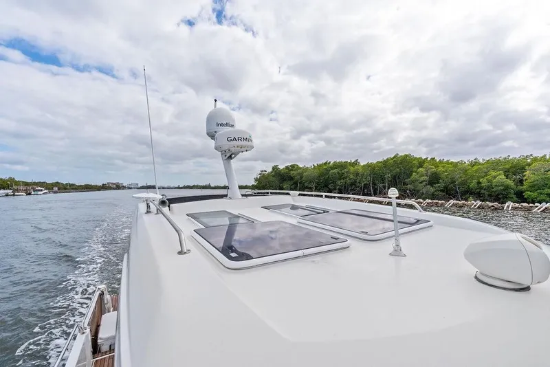 Slide: The Image of 2022 Beneteau Antares 11 cruising on a river with lush greenery. - 28