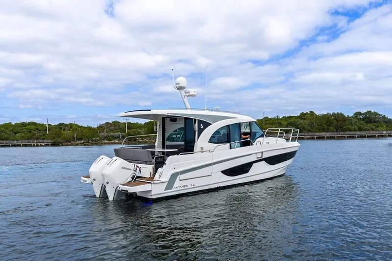 Slide: The Image of 2022 Beneteau Antares 11 boat cruising on a calm waterway under a partly cloudy sky. - 29