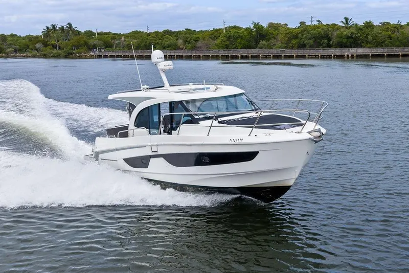 Slide: The Image of 2022 Beneteau Antares 11 cruising on a scenic waterway. - 5