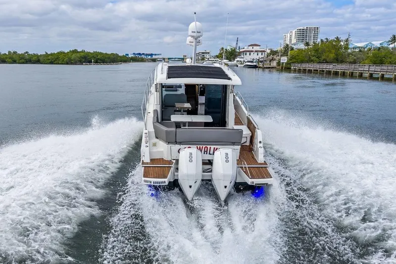 Slide: The Image of 2022 Beneteau Antares 11 cruising on a scenic waterway, showcasing powerful dual engines. - 6