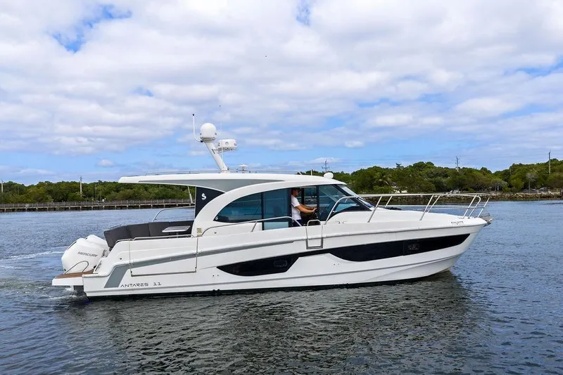 Slide: The Image of 2022 Beneteau Antares 11 cruising on calm waters under a cloudy sky. - 8