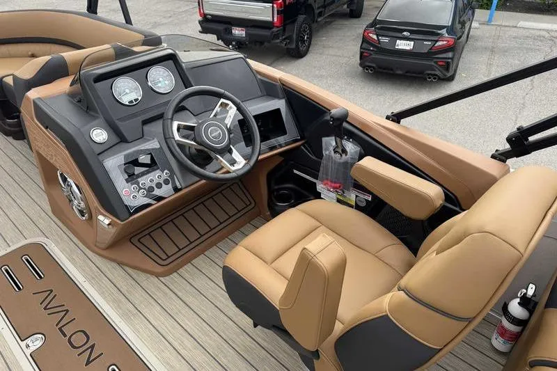 Slide: The Image of Interior view of 2026 Avalon 2385 25 Catalina QL boat with tan seating and control panel. - 10