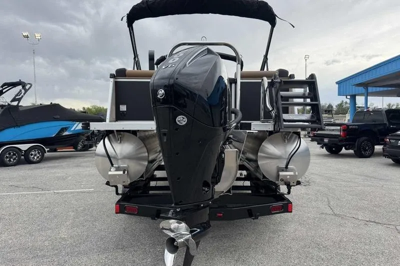 Slide: The Image of 2026 Avalon 2385 25 Catalina QL pontoon boat with powerful outboard motor, parked outdoors. - 7