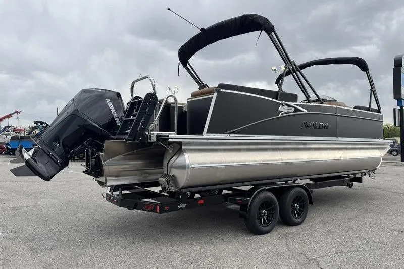 Slide: The Image of 2026 Avalon 2385 25 Catalina QL pontoon boat on trailer, featuring Mercury outboard motor. - 9