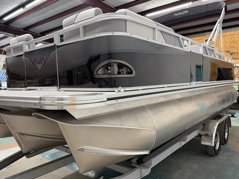 Slide: The Image of 2026 Avalon VNT VRB21T pontoon boat in a warehouse. - 11