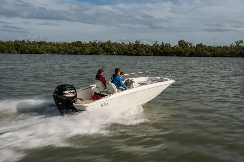 Slide: The Image of Two people ride a Boston Whaler 160 Super Sport on calm waters. - 12