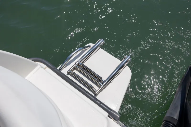 Slide: The Image of Stainless steel ladder on 2006 Boston Whaler 210 Outrage, above sparkling water. - 15