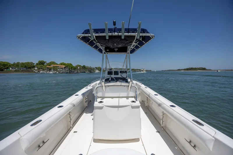 Slide: The Image of 2006 Boston Whaler 210 Outrage boat on calm water, clear sky background. - 16