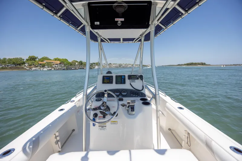 Slide: The Image of 2006 Boston Whaler 210 Outrage boat console with steering wheel and navigation equipment. - 18