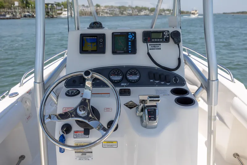 Slide: The Image of Boston Whaler 210 Outrage 2006 boat console with steering wheel and navigation equipment. - 19