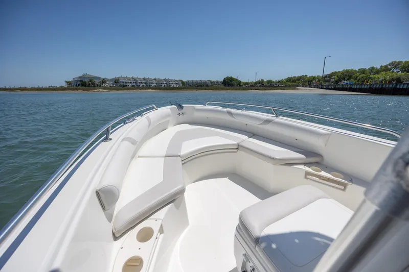 Slide: The Image of 2006 Boston Whaler 210 Outrage boat interior with seating, on calm water. - 24