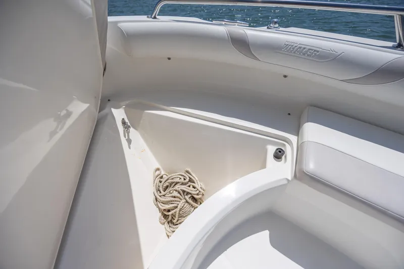Slide: The Image of Storage compartment on a 2006 Boston Whaler 210 Outrage boat with coiled rope. - 27