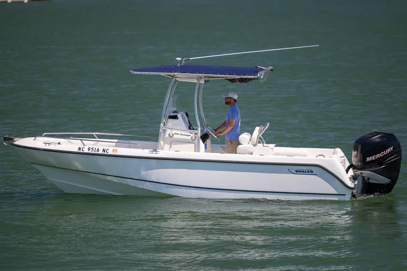 Slide: The Image of 2006 Boston Whaler 210 Outrage boat cruising on water with Mercury engine. - 5
