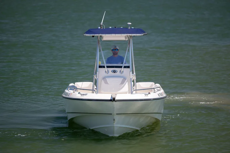 Slide: The Image of 2006 Boston Whaler 210 Outrage boat cruising on calm water. - 7