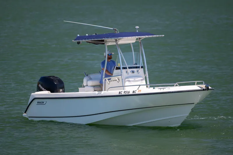 Slide: The Image of 2006 Boston Whaler 210 Outrage boat cruising on calm water. - 8