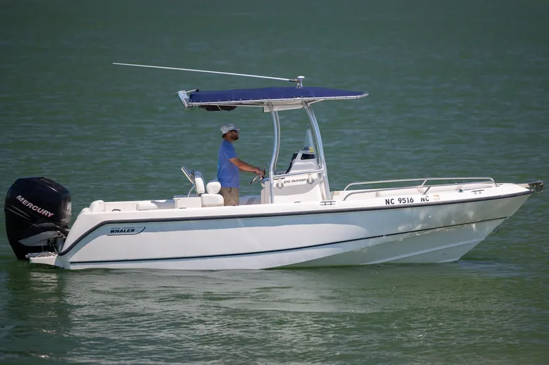 Slide: The Image of 2006 Boston Whaler 210 Outrage boat with Mercury engine on calm water. - 9