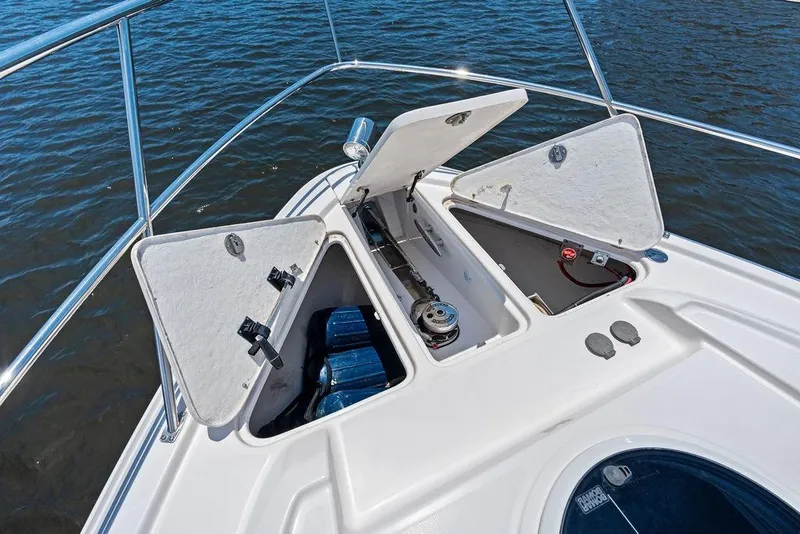 Slide: The Image of Open storage compartments on a 2013 Regal 42 Sport Coupe boat deck. - 14