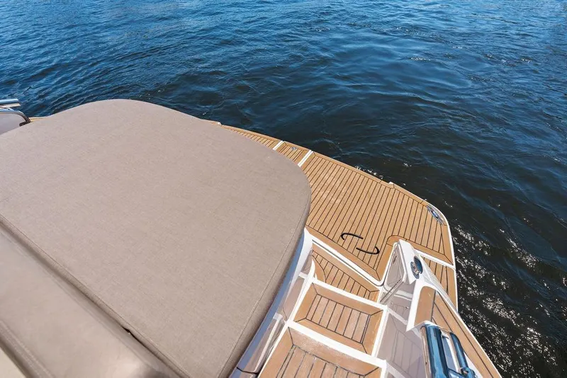 Slide: The Image of 2013 Regal 42 Sport Coupe's teak swim platform on calm water. - 19