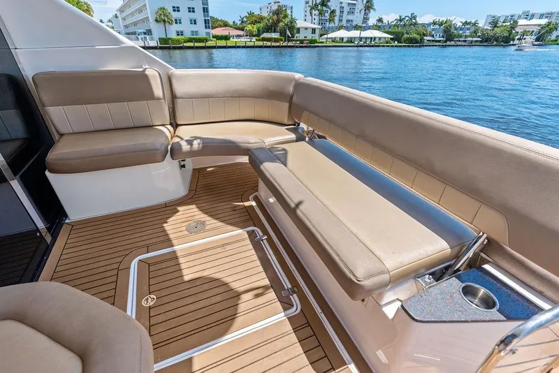 Slide: The Image of Luxurious seating area on 2013 Regal 42 Sport Coupe yacht, overlooking serene waterfront. - 20