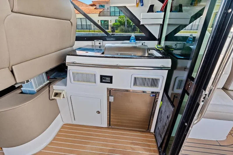 Slide: The Image of Interior of 2013 Regal 42 Sport Coupe yacht with kitchenette and seating area. - 23