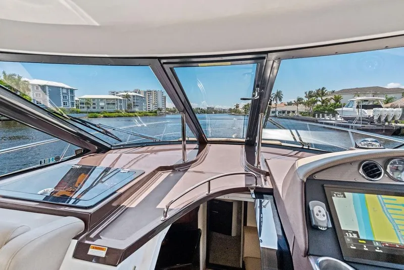 Slide: The Image of Interior view of 2013 Regal 42 Sport Coupe yacht navigating a scenic waterway. - 25