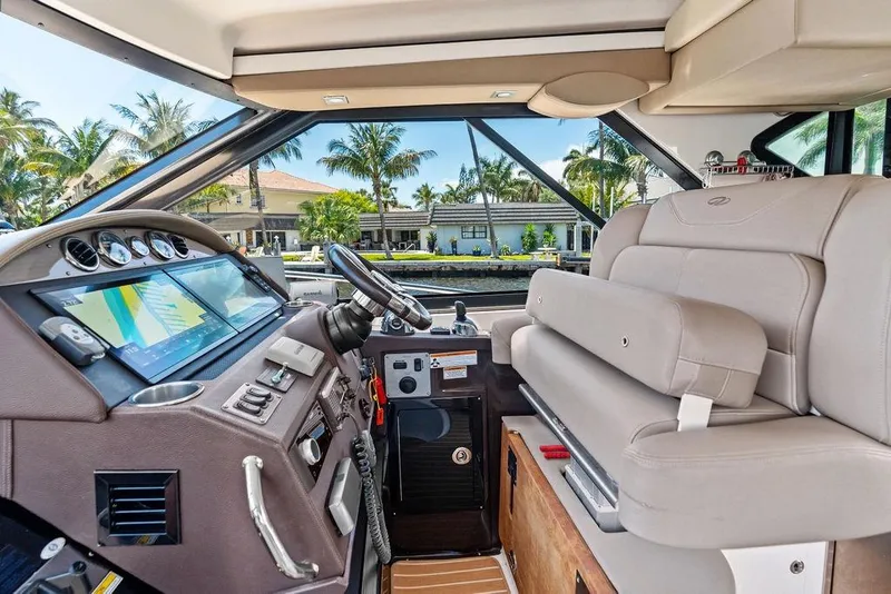 Slide: The Image of Interior of a 2013 Regal 42 Sport Coupe yacht with modern dashboard and seating. - 26