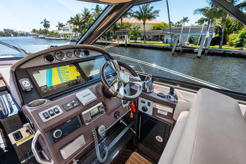 Slide: The Image of Cockpit of 2013 Regal 42 Sport Coupe with navigation system and waterfront view. - 29