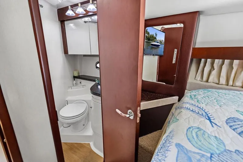 Slide: The Image of 2013 Regal 42 Sport Coupe interior with bathroom and cozy bedroom. - 37
