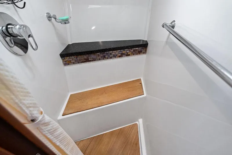 Slide: The Image of Shower area in 2013 Regal 42 Sport Coupe with wooden steps and modern fixtures. - 39