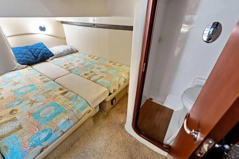 Slide: The Image of Cozy cabin interior of 2013 Regal 42 Sport Coupe with twin beds and private bathroom. - 40