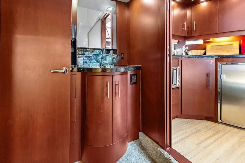 Slide: The Image of Luxurious interior of 2013 Regal 42 Sport Coupe yacht with modern wood cabinetry and glass sink. - 42