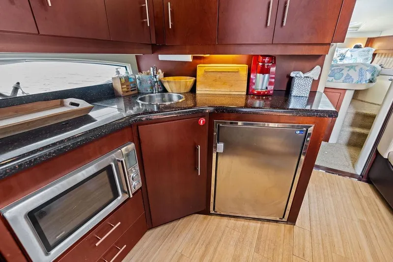 Slide: The Image of Modern kitchen interior of 2013 Regal 42 Sport Coupe yacht with sleek cabinetry and appliances. - 43