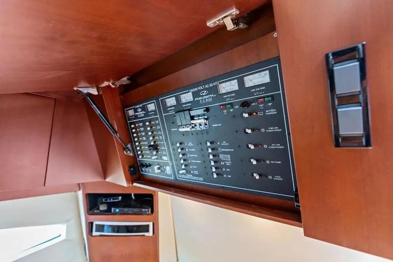 Slide: The Image of Control panel of a 2013 Regal 42 Sport Coupe yacht, featuring various switches and indicators. - 48