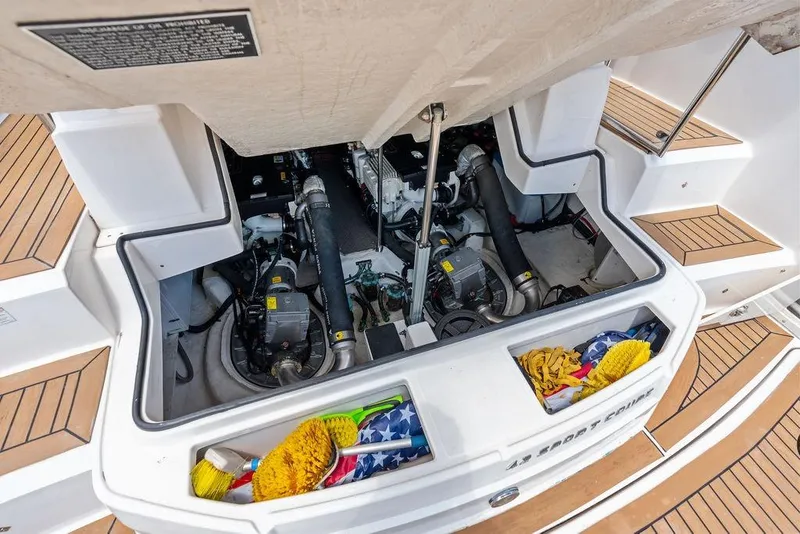Slide: The Image of Engine compartment of a 2013 Regal 42 Sport Coupe with cleaning supplies. - 50