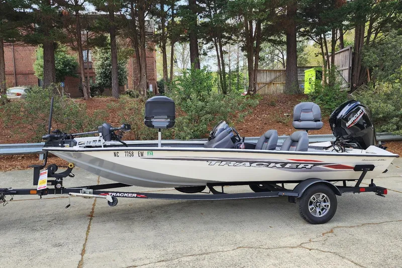 The Image of 2022 Tracker Pro Team 175 TXW fishing boat on trailer, parked outdoors. - 0