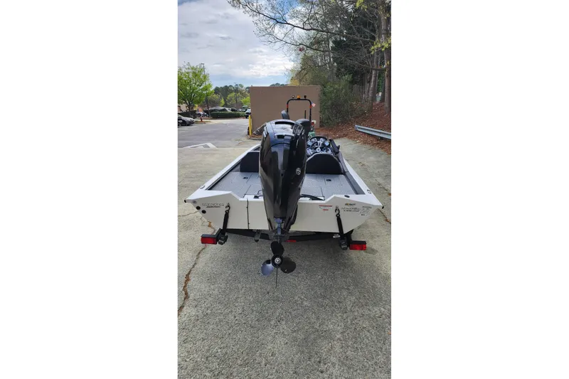 Slide: The Image of 2022 Tracker Pro Team 175 TXW boat, rear view, parked outdoors. - 2