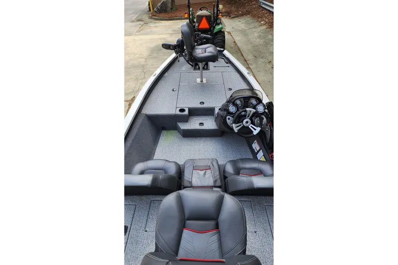 Slide: The Image of 2022 Tracker Pro Team 175 TXW boat interior with seating and steering console. - 3