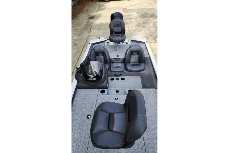 Slide: The Image of 2022 Tracker Pro Team 175 TXW boat interior with gray seating and console. - 4
