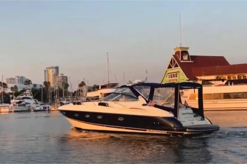 The Image of Sunseeker Camargue 44 yacht from 2001 cruising in a marina at sunset. - 1