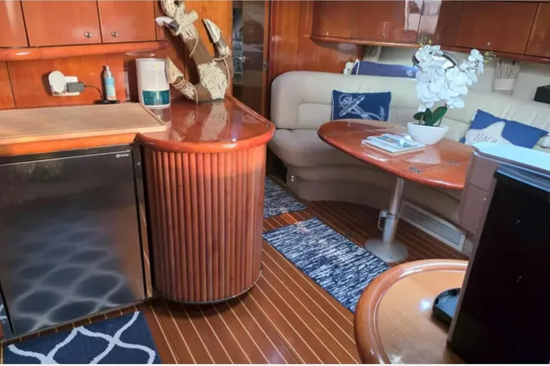 Slide: The Image of Luxurious interior of 2001 Sunseeker Camargue 44 yacht with elegant wood finishes and cozy seating. - 10